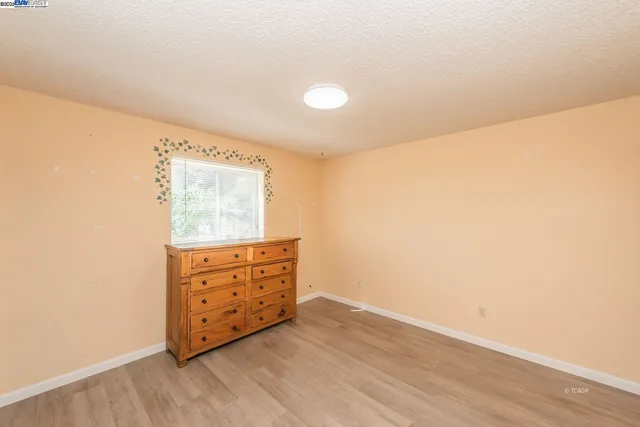 a room with painting on the wall and a window