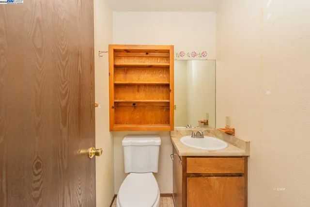 a bathroom with a toilet a sink and mirror