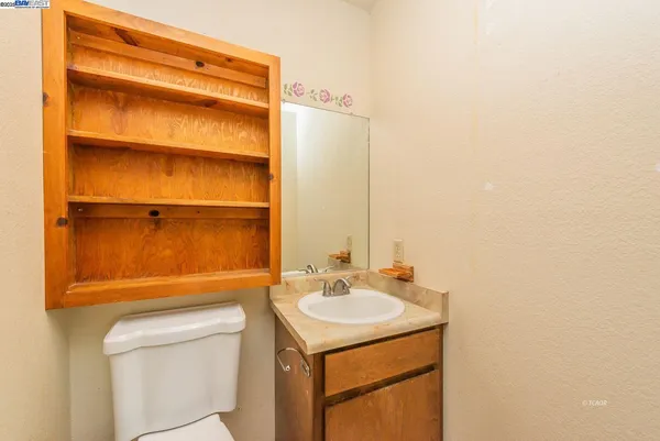 a bathroom with a sink toilet and vanity