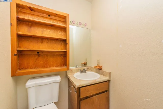 a bathroom with a sink toilet and vanity