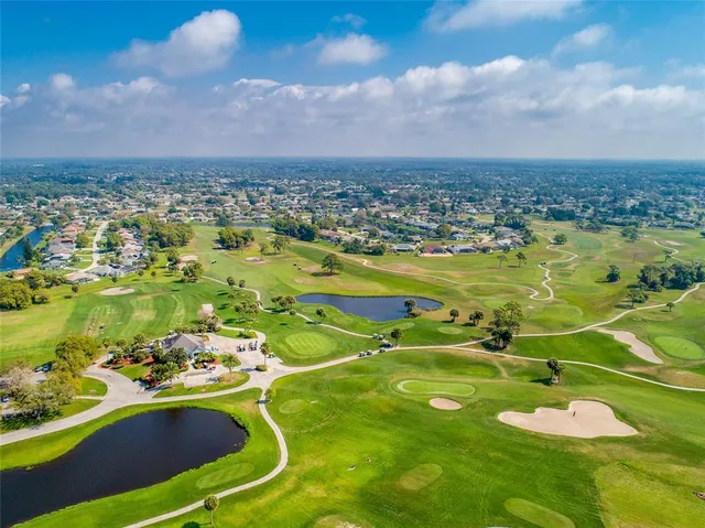 an aerial view of a houses with a swimming pool