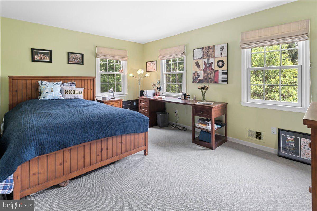 1873 Stuart Road West Princeton, NJ 08540 - Photo 35 of 46 a bedroom with a bed and a table in it