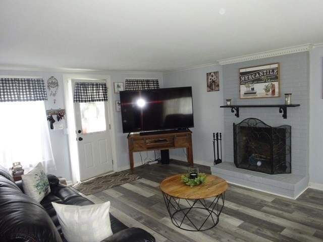 15 Cranberry Road Sagamore, MA 02561 - Photo 14 of 42 a living room with furniture a flat screen tv and a fireplace