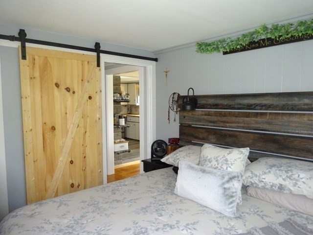15 Cranberry Road Sagamore, MA 02561 - Photo 19 of 42 a bedroom with a bed and a dresser