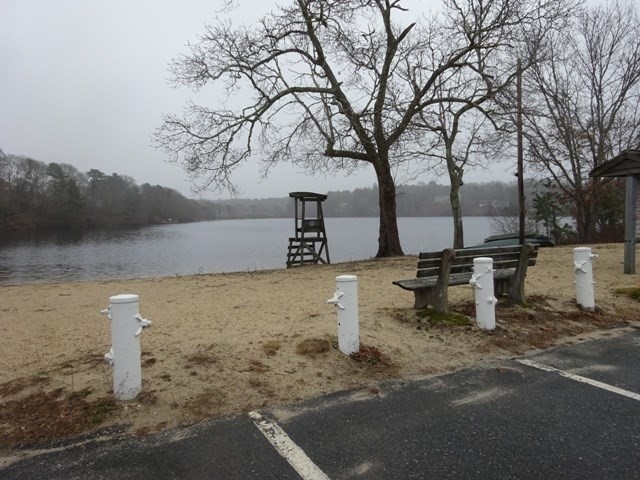 15 Cranberry Road Sagamore, MA 02561 - Photo 36 of 42 a view of a ocean with a bench and trees around