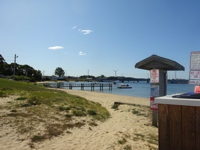 15 Cranberry Road Sagamore, MA 02561 - Photo 37 of 42 a view of a lake with a table and chairs under an umbrella