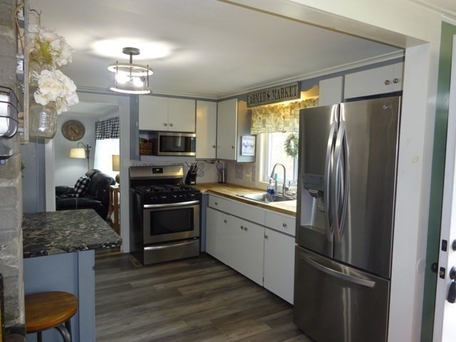 15 Cranberry Road Sagamore, MA 02561 - Photo 6 of 42 a kitchen with granite countertop a refrigerator stove and microwave