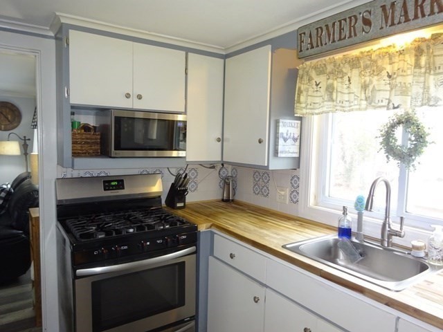 15 Cranberry Road Sagamore, MA 02561 - Photo 9 of 42 a kitchen with a sink stove and microwave
