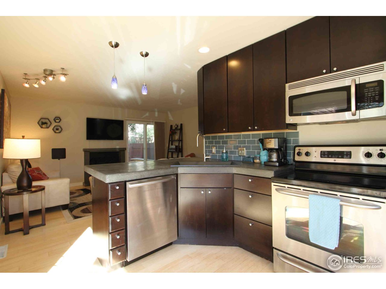 4115 Riverside Avenue Boulder, CO 80304 - Photo 3 of 24 a kitchen with stainless steel appliances kitchen island granite countertop a stove a sink and a microwave