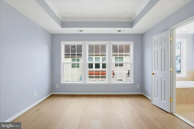 a bathroom with a tub a sink and mirror