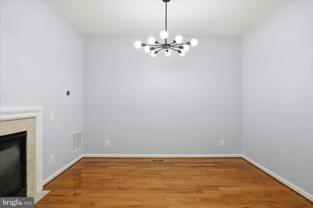 a kitchen with stainless steel appliances granite countertop a stove a sink dishwasher and a microwave oven with wooden cabinets