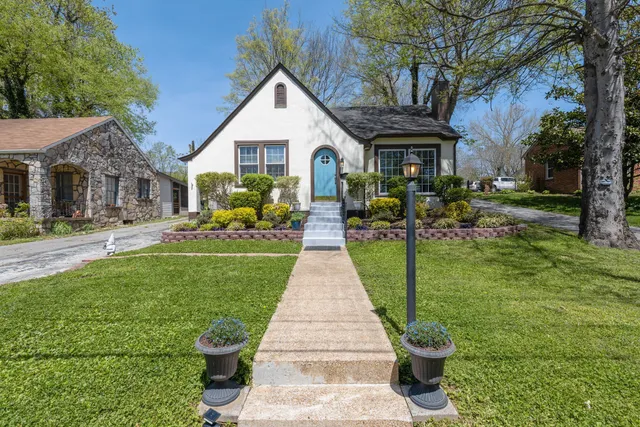 a front view of a house with garden and patio