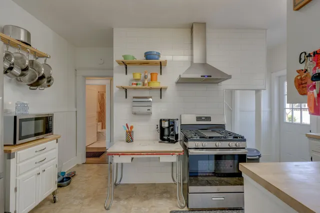 a kitchen with stainless steel appliances a stove and a refrigerator