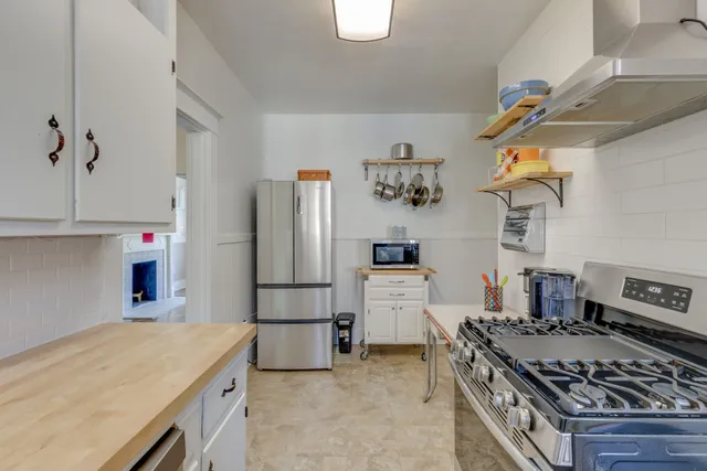 a kitchen with stainless steel appliances granite countertop a stove and a refrigerator