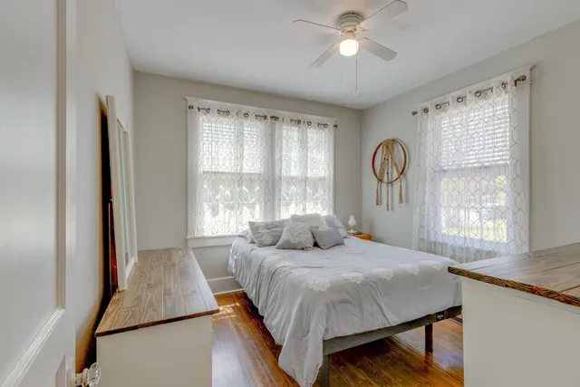 a bedroom with a large bed and a window