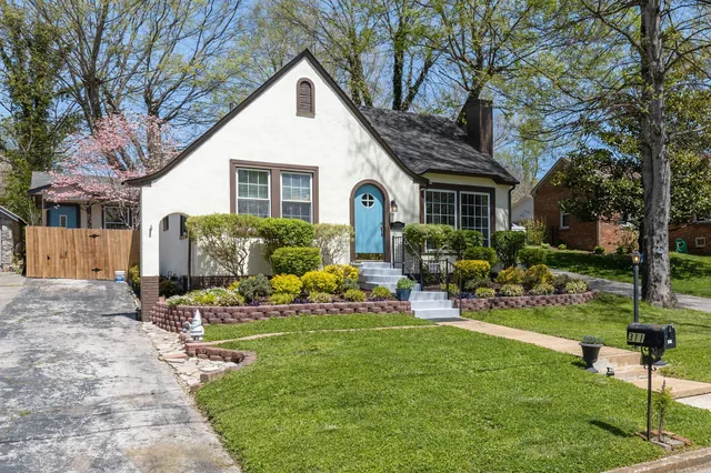 a view of a house with backyard sitting area and garden