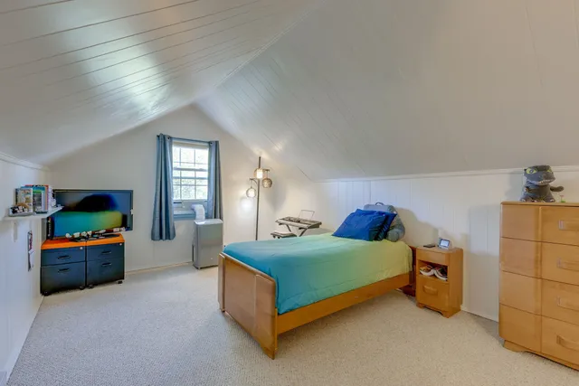 a bedroom with bed and window