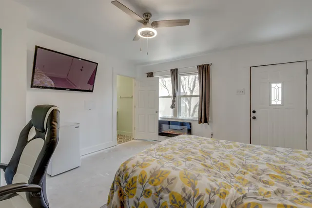 a bedroom with a bed and a window