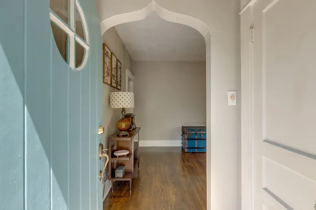 a view of entryway and hall with wooden floor