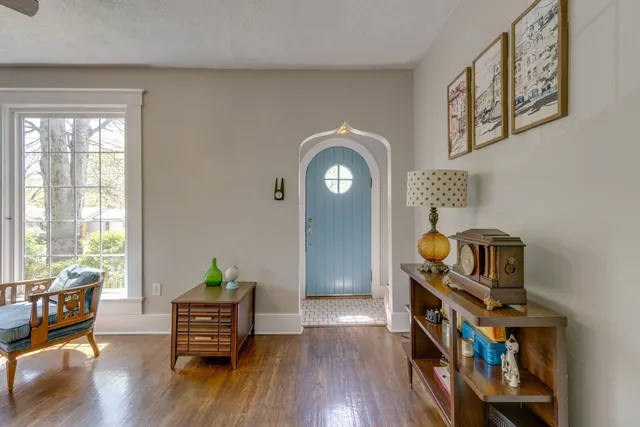 a view of room with wooden floor and furniture