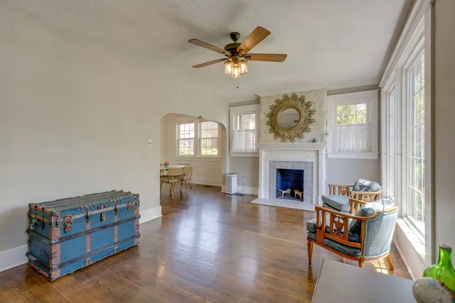 a living room with furniture fireplace and window