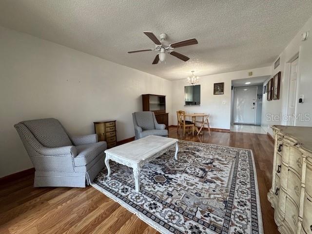 11485 Oakhurst Road, Unit 319 Largo, FL 33774 - Photo 3 of 63 a living room with furniture and a wooden floor