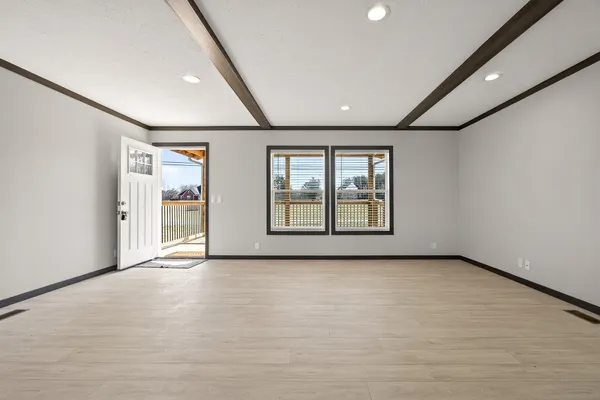 an empty room with windows and closet
