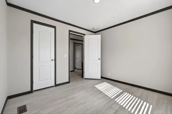a view of empty room with wooden floor