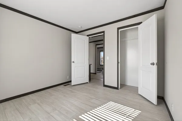 a view of a room with wooden floor and a bathroom