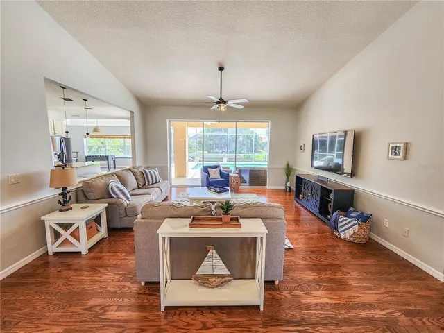 a view of a dining room with furniture wooden floor and chandelier