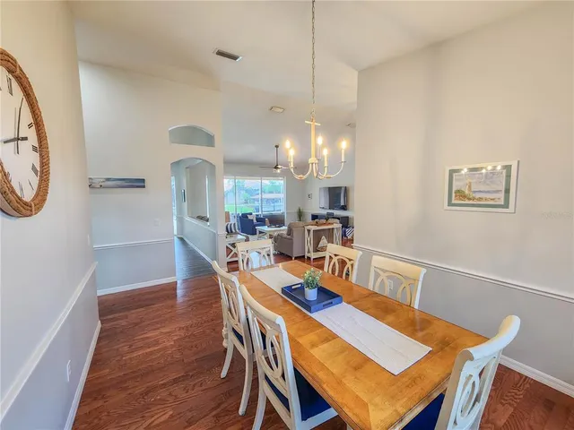 a large kitchen with a table chairs refrigerator and microwave