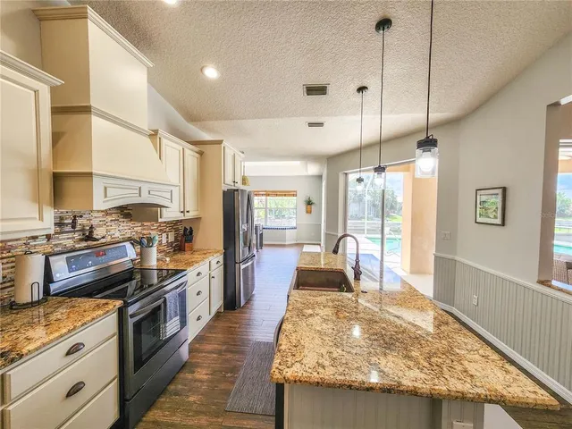a living room with furniture flat screen tv and a large window
