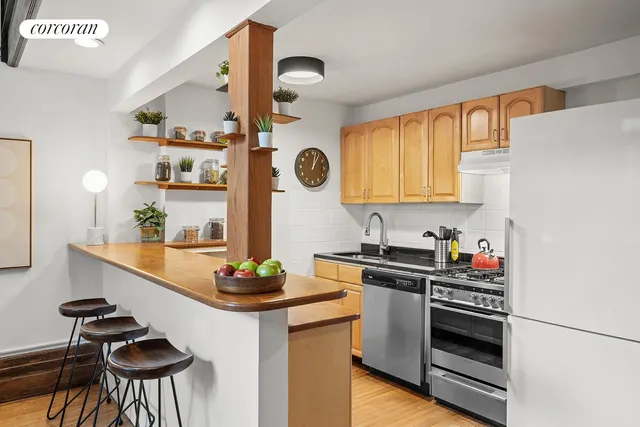 a kitchen with stainless steel appliances a stove a sink and a refrigerator