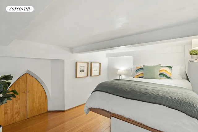 a bedroom with a bed and dresser