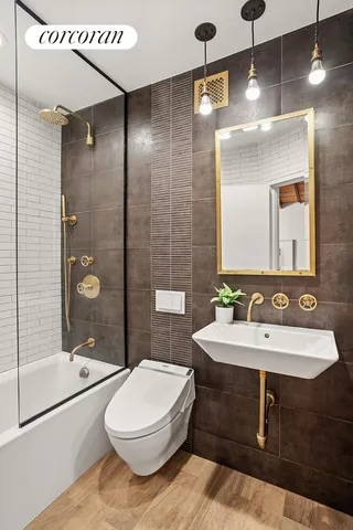 a bathroom with a sink a toilet a mirror and shower