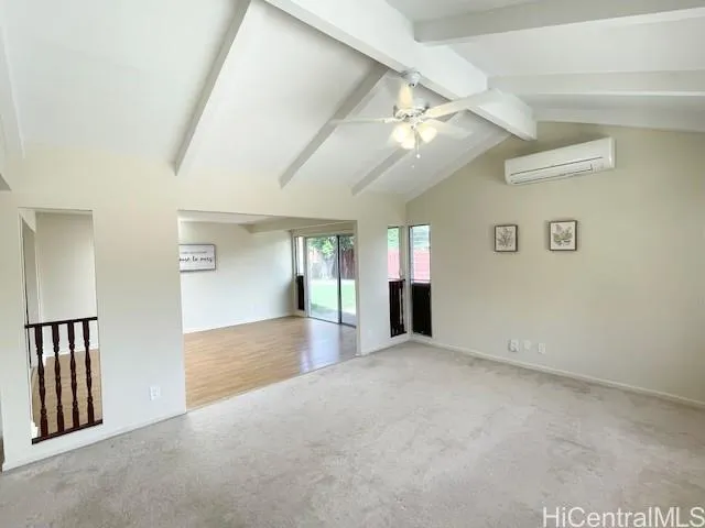 an empty room with windows and ceiling fan