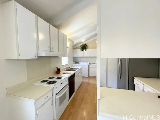 a kitchen with a stove a sink and a refrigerator