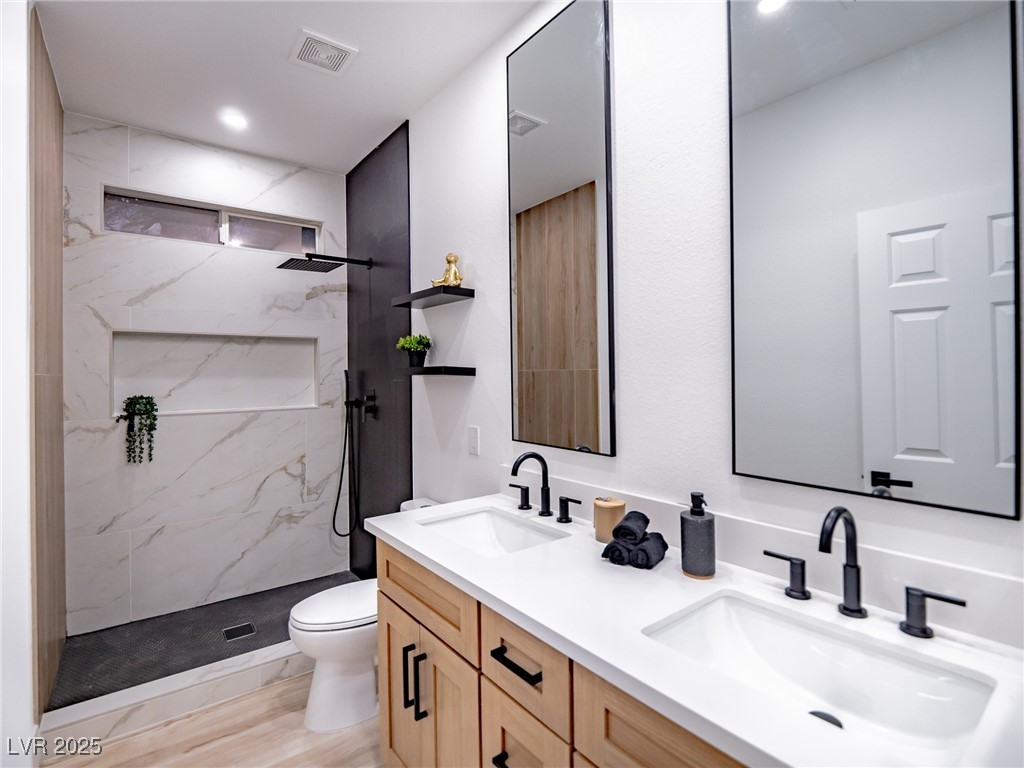 7870 Midnight Ride Street Las Vegas, NV 89131 - Photo 30 of 69 Full bath with double vanity and a marble finish shower