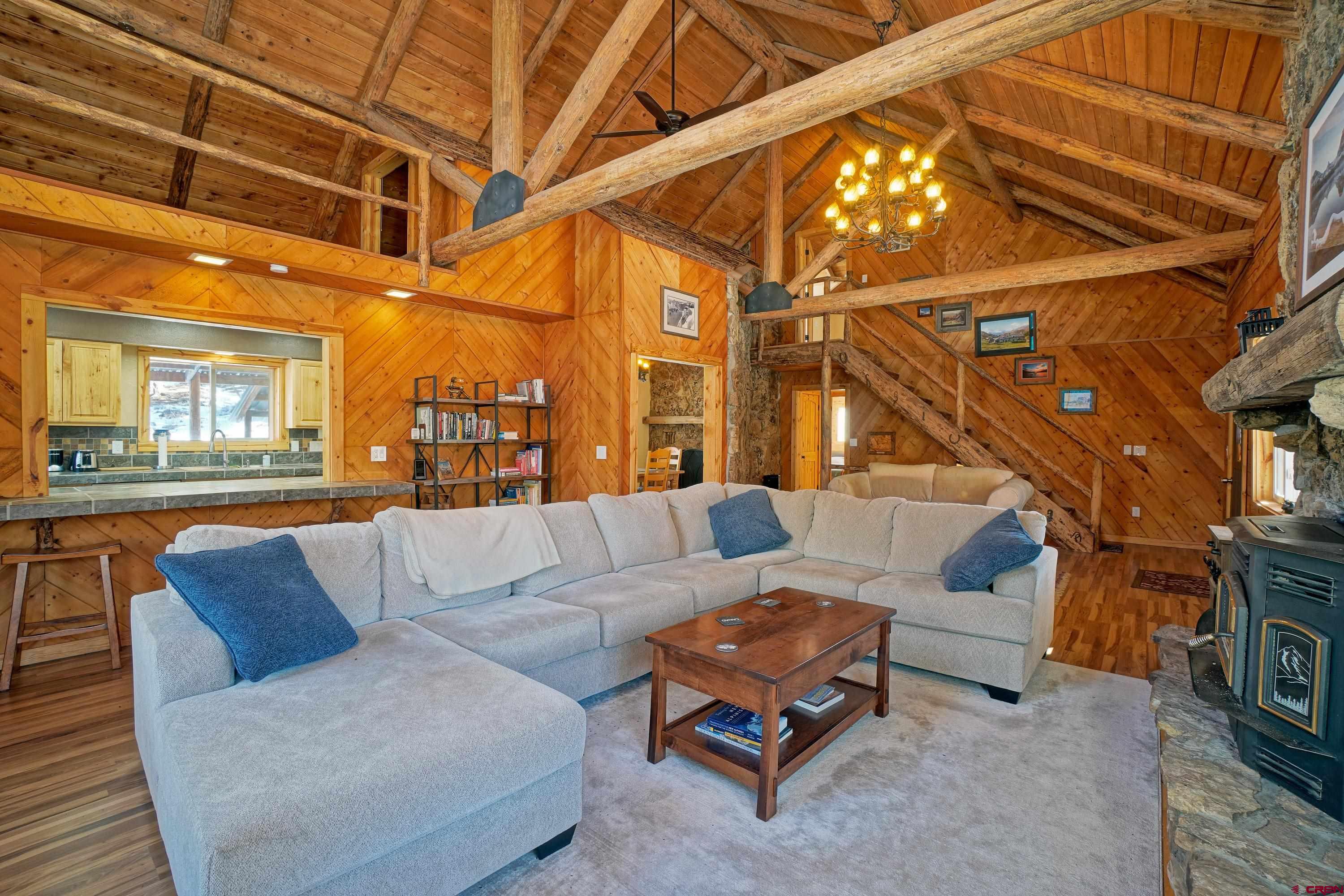 448 Whitehouse Vista Lane Ridgway, CO 81432 - Photo 7 of 34 a living room with furniture and a chandelier