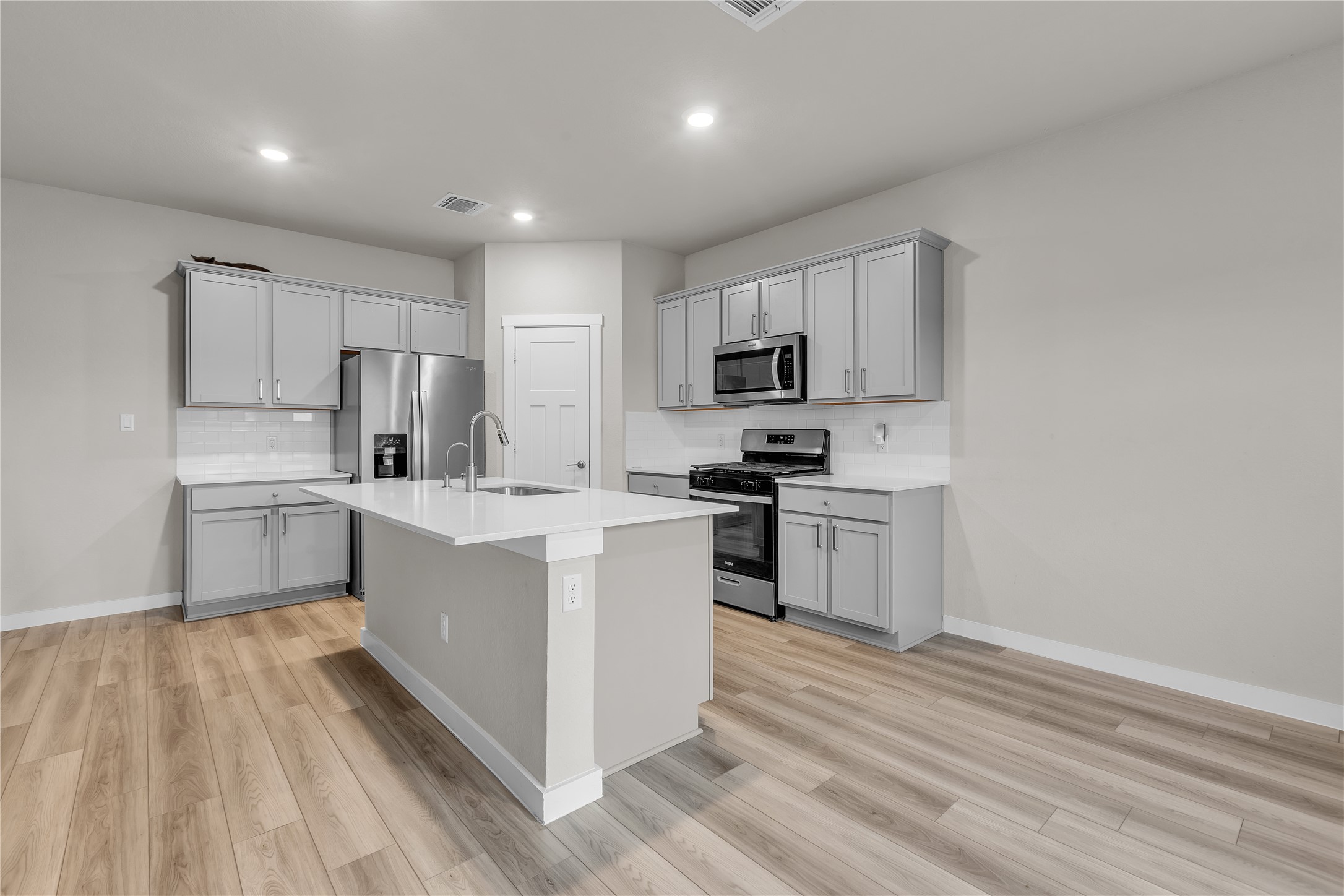 1212 Tipton Street Georgetown, TX 78633 - Photo 6 of 20 A well-lit kitchen with sleek stainless steel appliances and abundant counter space.