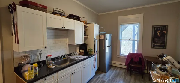 a kitchen with a sink appliances and cabinets