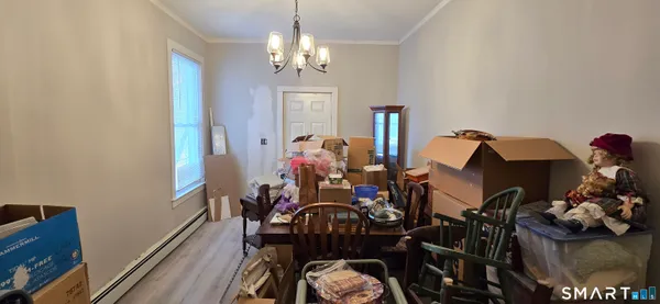 a view of a dining room with furniture and chandelier