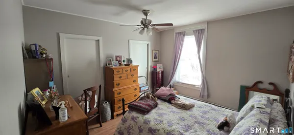 a bedroom with furniture and a window