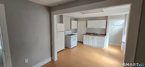 a kitchen with white cabinets and a sink
