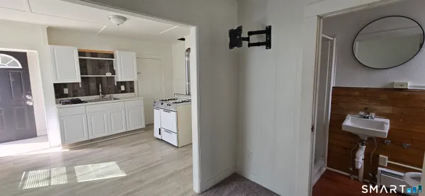 a view of a kitchen with a sink and a refrigerator