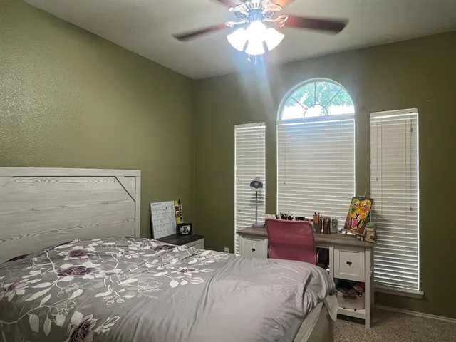 a bedroom with bed and a window
