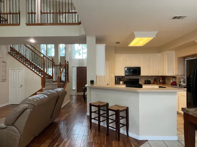 a living room with furniture fireplace and a flat screen tv