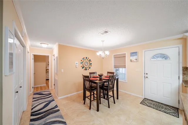 a view of a dining room with furniture and chandelier