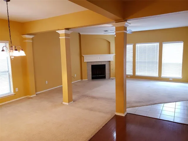 a view of a livingroom with a fireplace and window