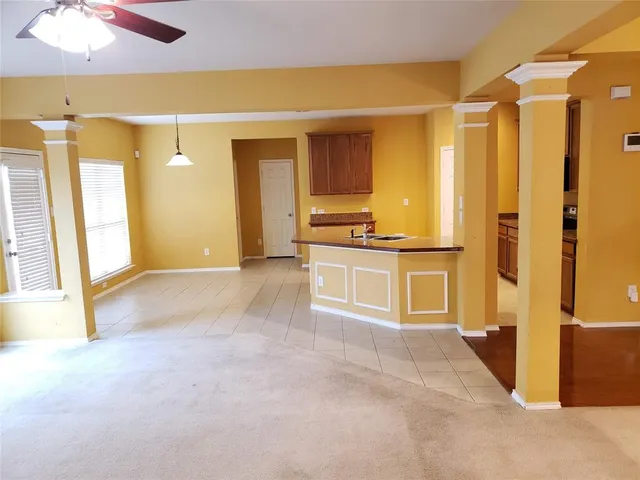 a view of a kitchen with a sink and cabinets